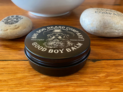 Close-up of Cowboy Crush Good Boy Beard Balm, blending rich cedarwood, oakmoss, black pepper, and coffee scents in a premium tin.