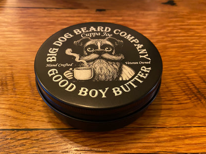 A tin of Cuppa Joe GOOD BOY Beard Butter by Big Dog Beard Company, closeup on tabletop