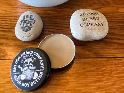 A tin of Cuppa Joe GOOD BOY Beard Butter by Big Dog Beard Company, closeup on table, top view open lid