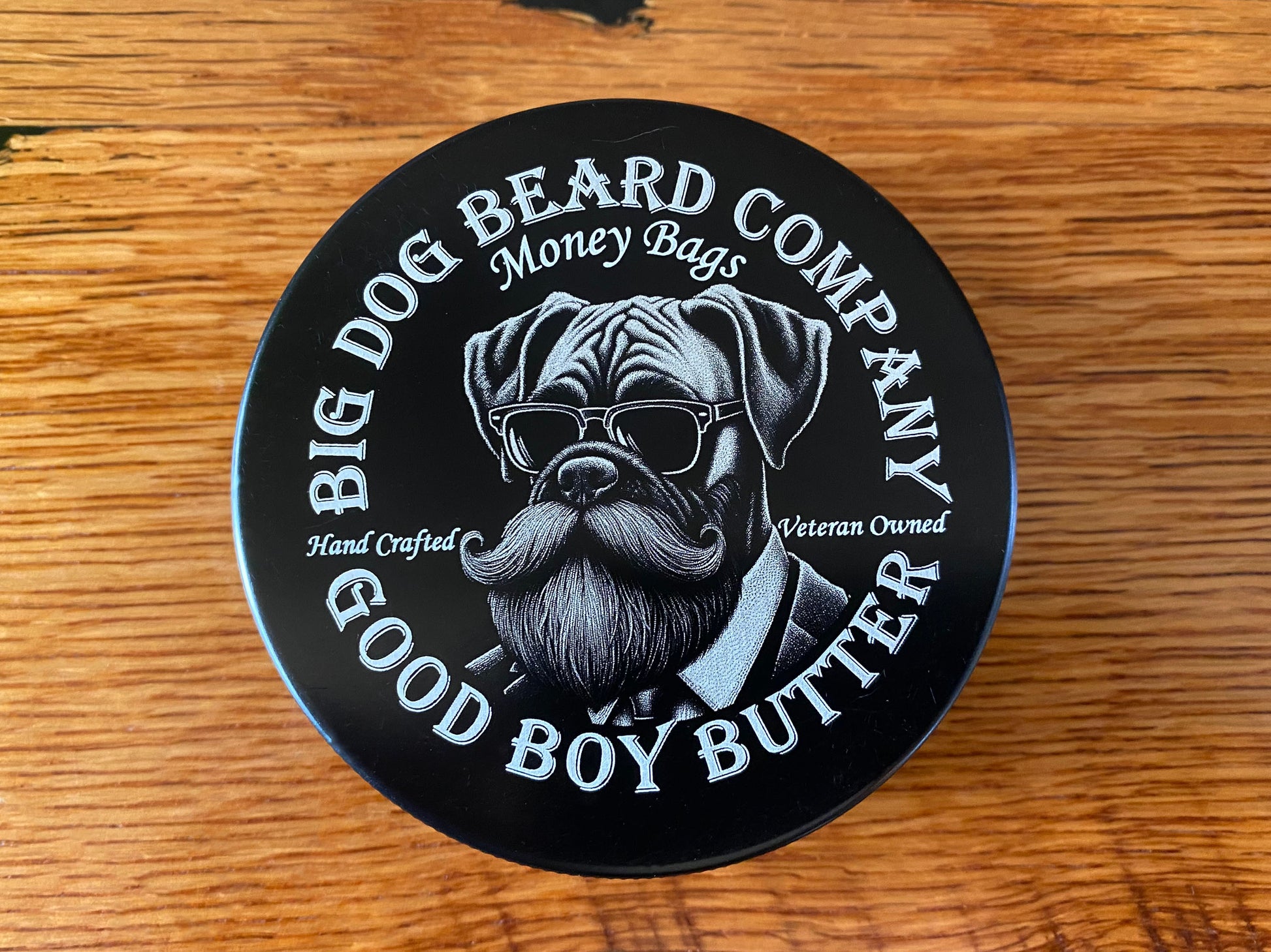 A tin of Money Bags Good Boy Beard Butter by Big Dog Beard Company, featuring an elegant design that embodies the spirit of success.