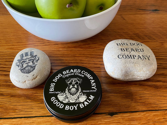 A tin of Tropical Dream Good Boy Beard Balm by Big Dog Beard Company, featuring an elegant design that embodies the spirit of a resort vacation.