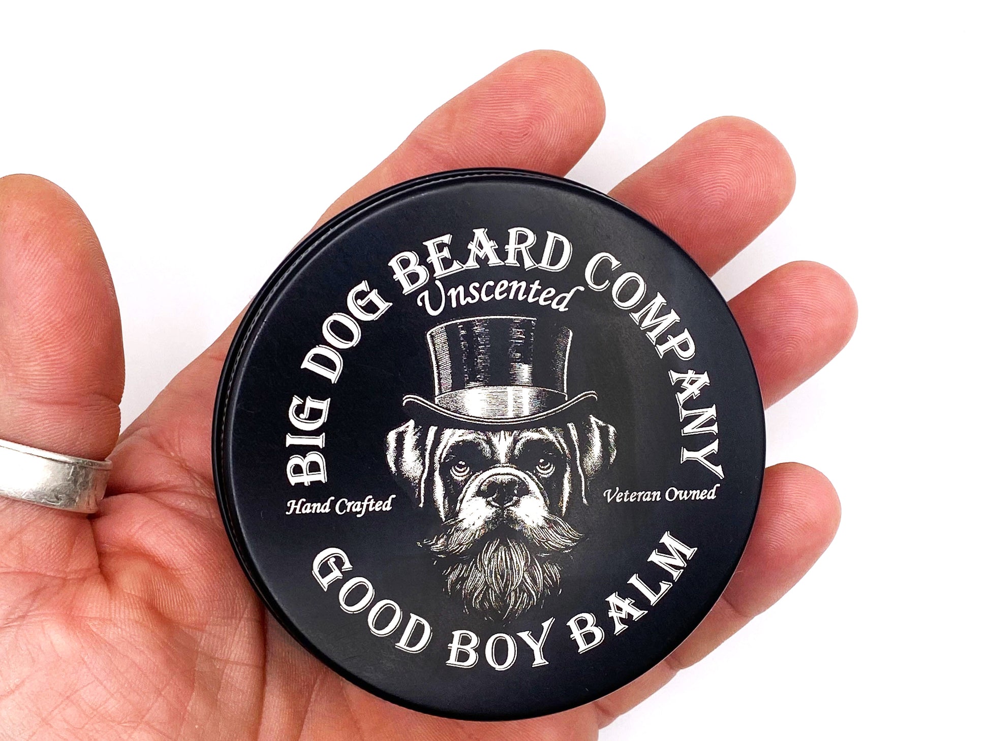 A tin of Big Dog Beard Company Unscented GOOD BOY Beard Balm held in hand.